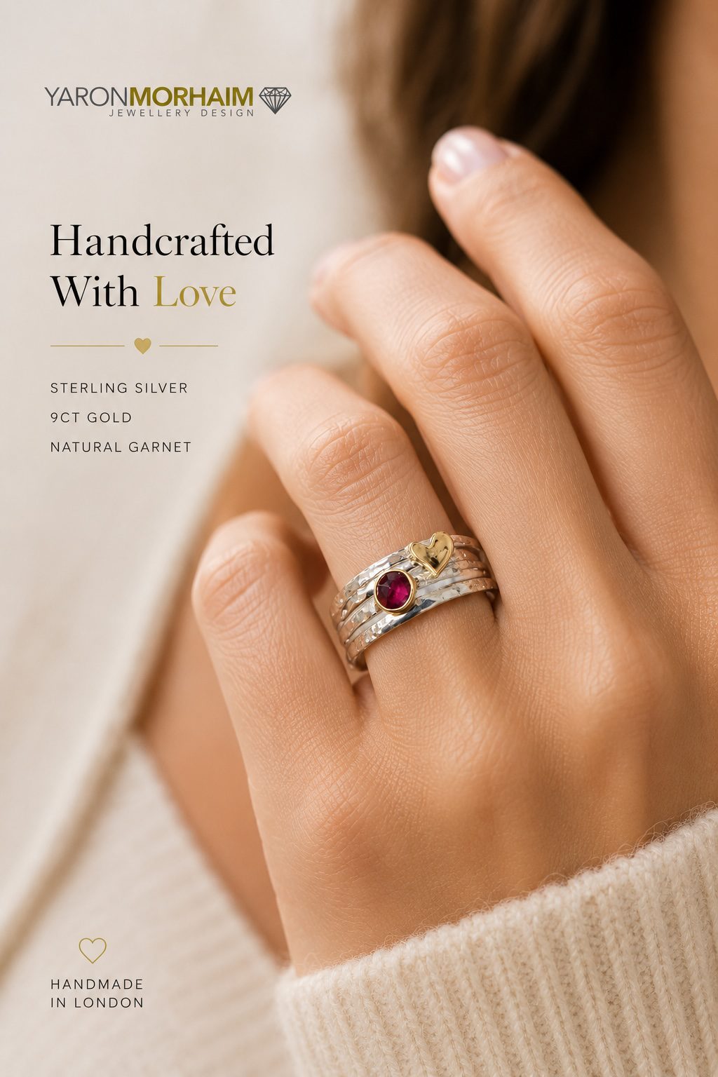 Woman wearing handcrafted sterling silver garnet ring with 9ct gold heart detail
