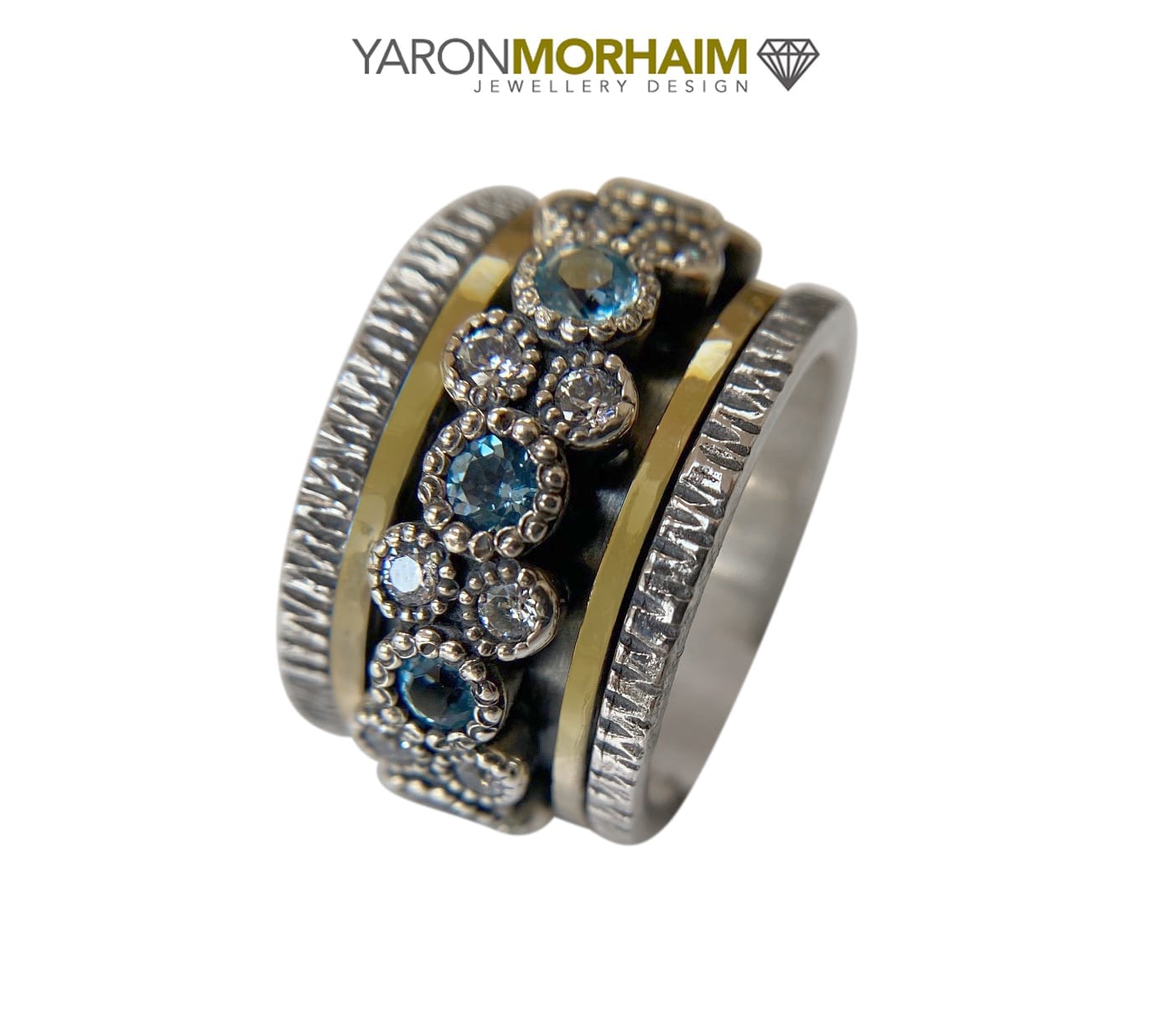 silver and gold blue topaz halo ring angled showing gemstone brilliance