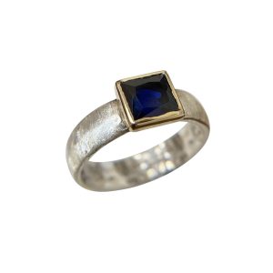 Silver and gold sapphire ring with square blue gemstone