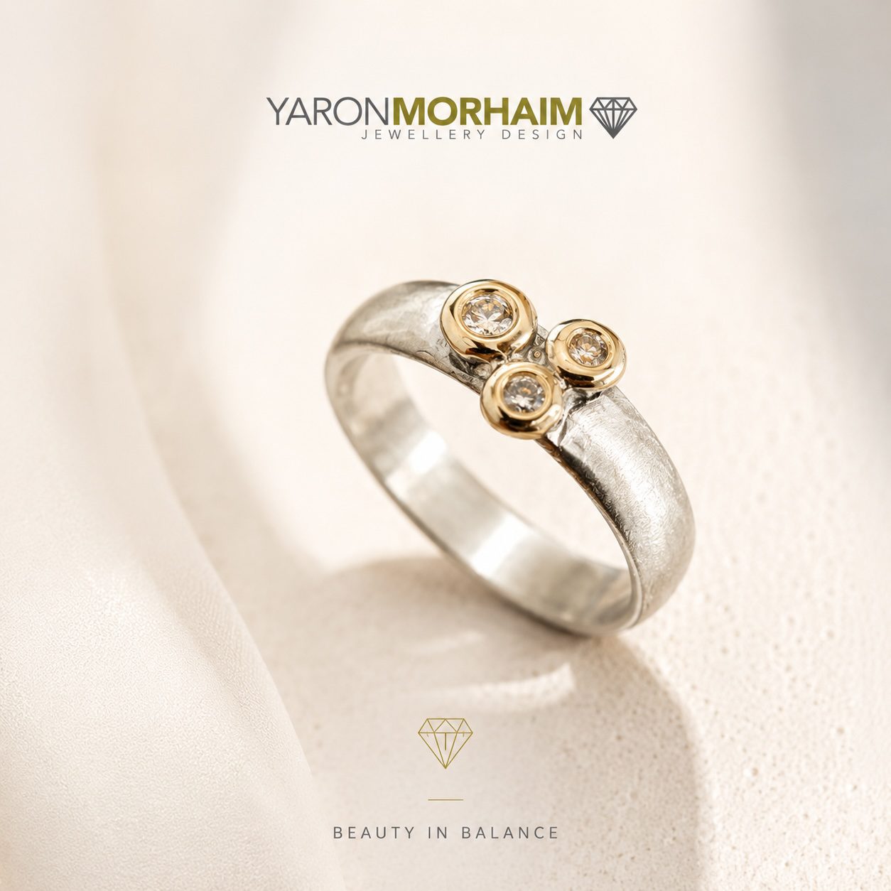 Handcrafted sterling silver ring with three cubic zirconia stones in 9ct gold settings by Yaron Morhaim Jewellery Design.