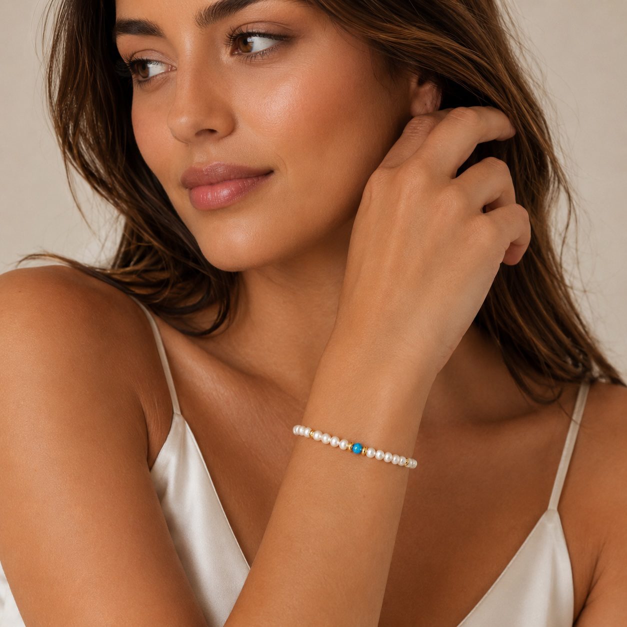 Female model wearing handcrafted freshwater pearl and opal bracelet