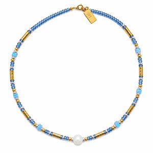 Woman wearing Twilight Cascade Tanzanite Necklace handcrafted with natural Tanzanite and Opal gemstones